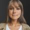 Picture of Kyle Soucy featuring a woman with long light brown hair wearing a white shirt with a beige jacket.