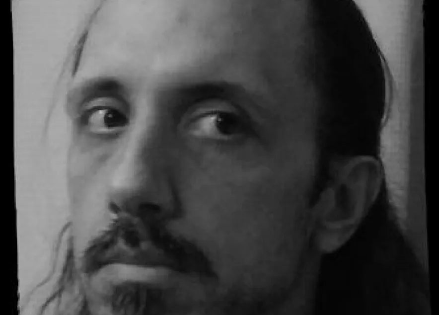 Head shot of Chris Thompson in black and white, sporting a mustache with soul patch.