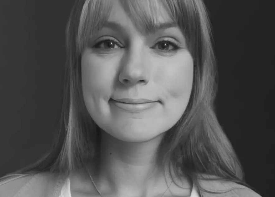 Picture of Kyle Soucy featuring a woman with long light brown hair wearing a white shirt with a beige jacket.